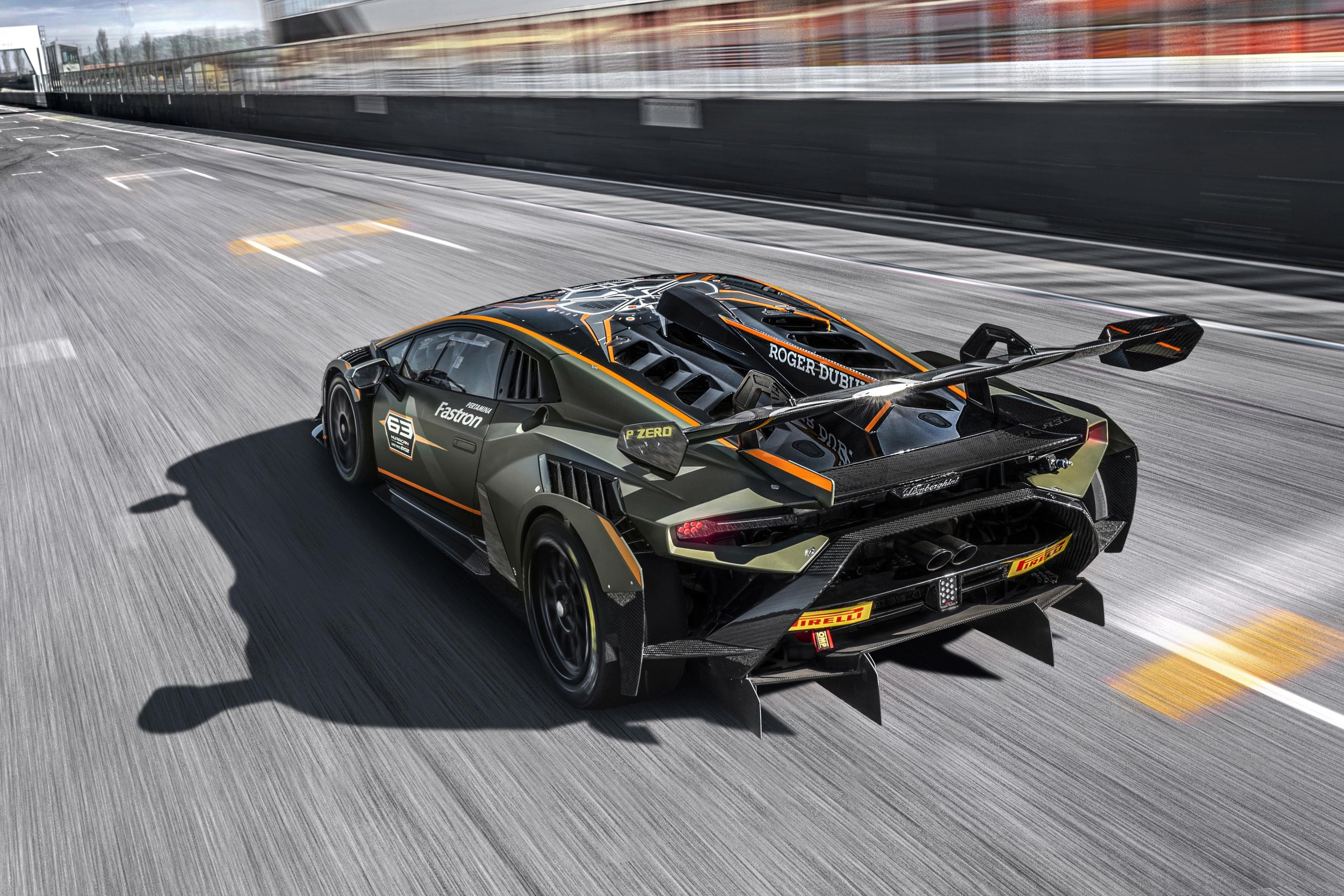 Rear view of a lamborghini huracán super trofeo evo2 at speed showing the massive rear diffuser, wing, and racing number 63