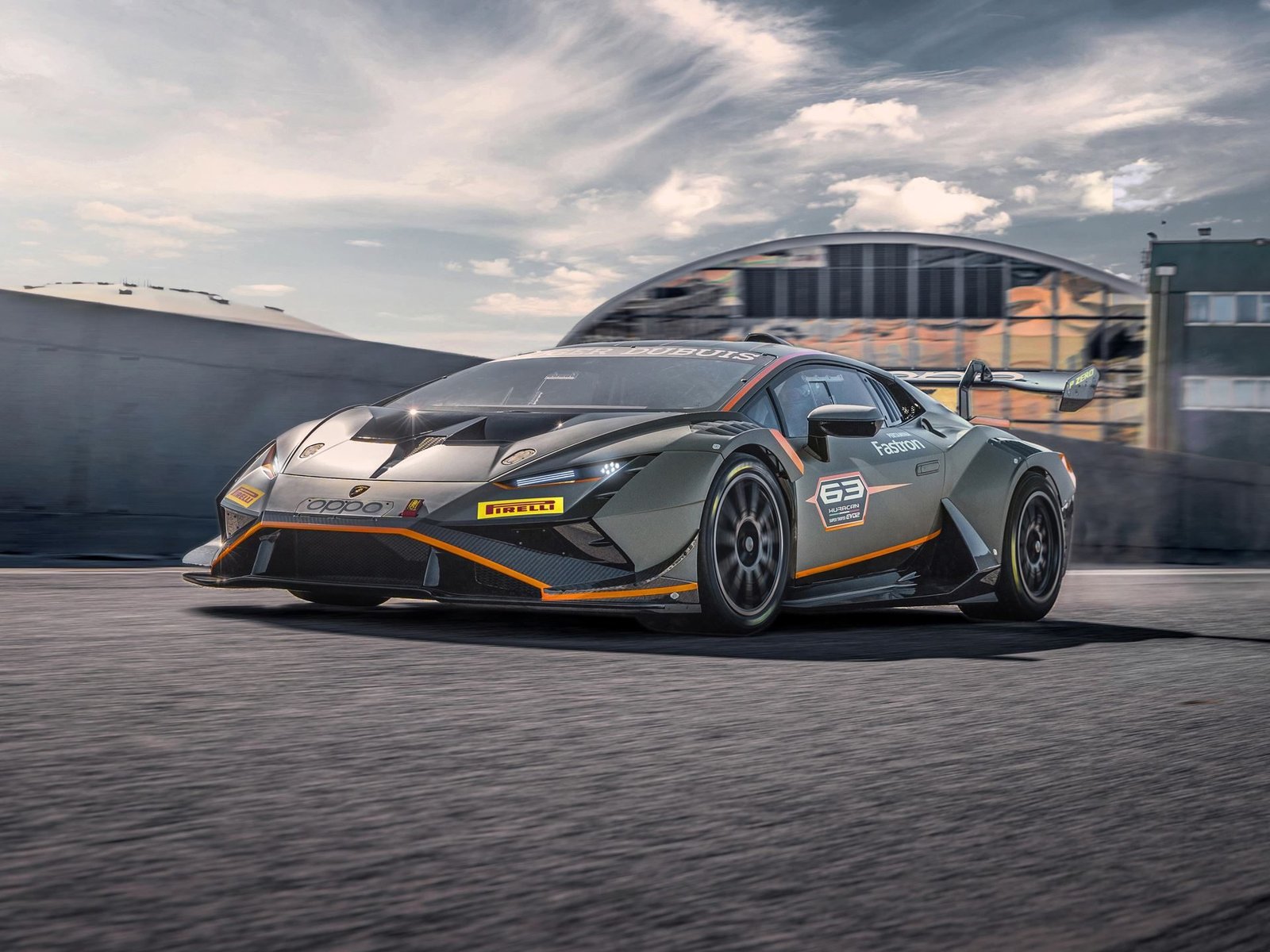 Lamborghini Huracán Super Trofeo EVO2 in matte grey with orange accents racing at speed on a circuit