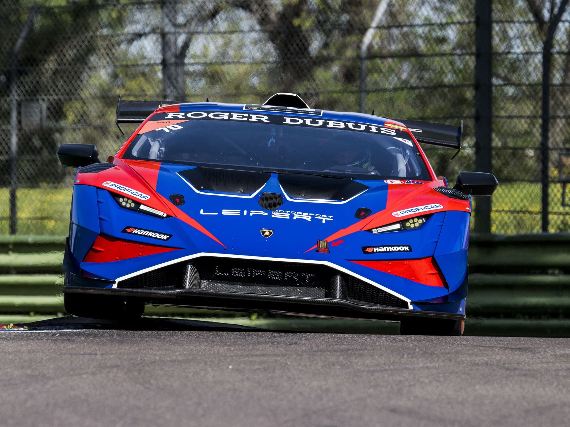Super Trofeo Europe Joins The Fia Wec Bill At Imola, Placing Lamborghini'S Full Racing Ladder On One Stage 5 Close-up front view of a blue and red lamborghini huracán super trofeo evo2 race car cornering on a racetrack