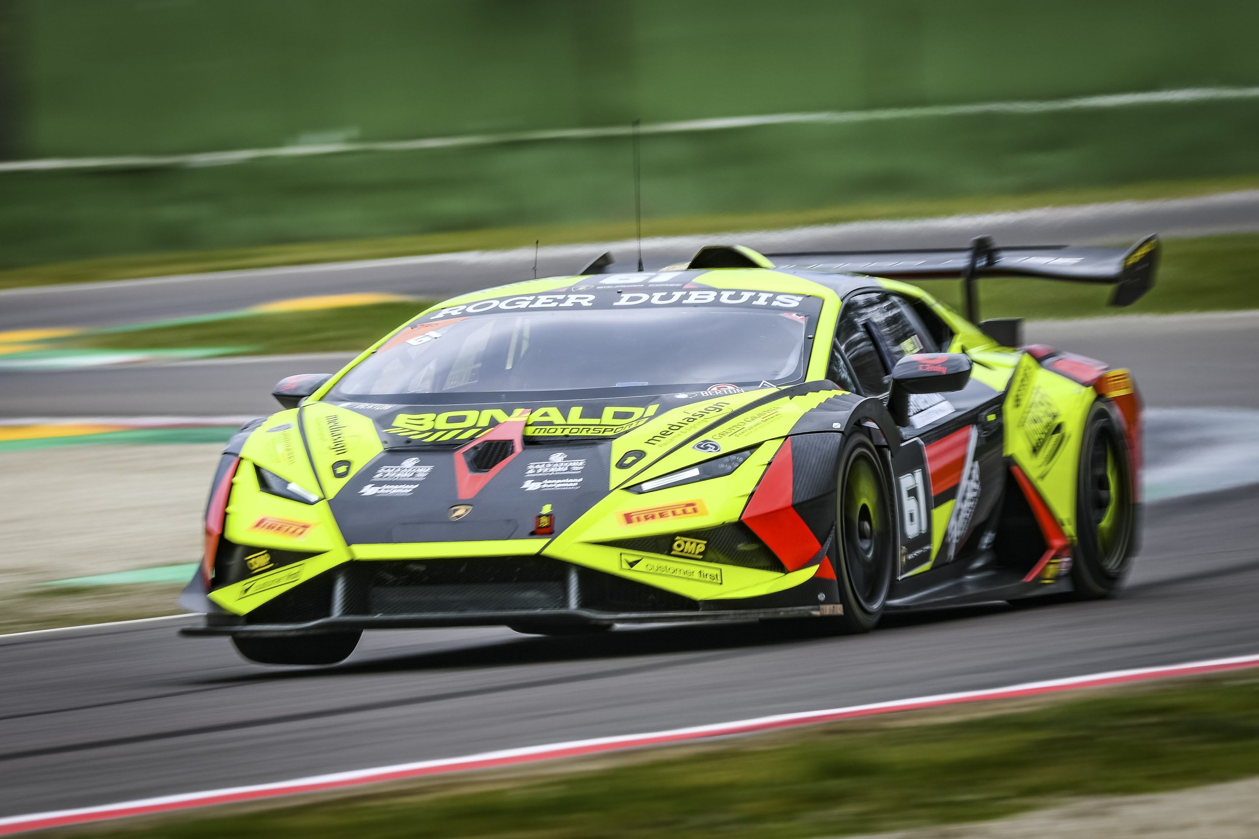 Pedrosa Returns, A Perfect Streak Faces Misano'S Evening Grid, And Four Classes Fight For Points 9 A lime green and black lamborghini huracán super trofeo evo2 number 61 at speed with motion blur emphasizing velocity
