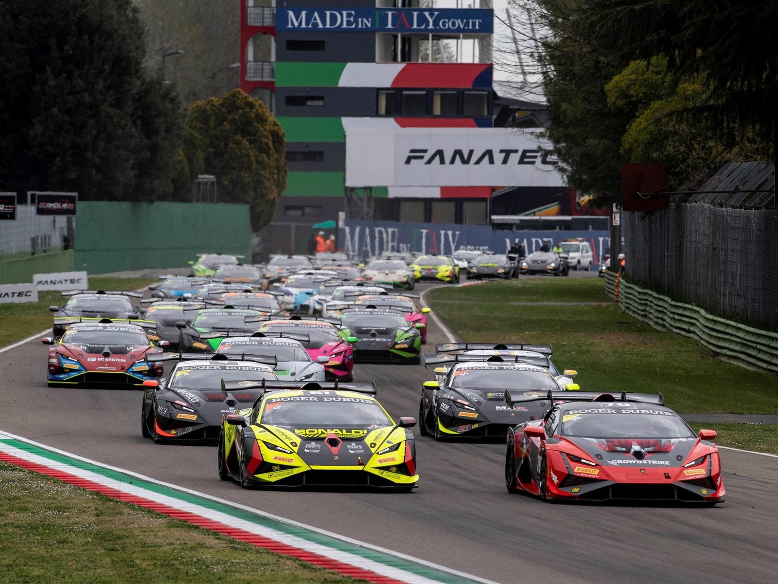 A pack of Lamborghini Huracán Super Trofeo EVO2 race cars battling on track during a Super Trofeo Europe race