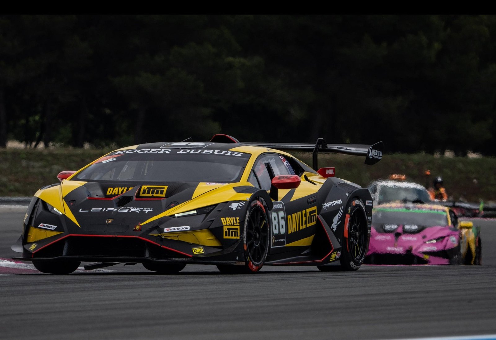 Yellow and black Lamborghini Huracán Super Trofeo EVO2 number 86 racing on track with prominent rear wing and Roger Dubuis livery
