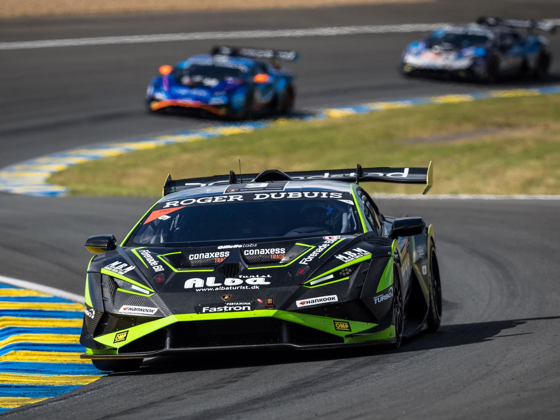 Super Trofeo Europe Hits The Nürburgring With A 1.5-Point Pro Title Fight 3 A black and neon green lamborghini huracán super trofeo evo2 takes a sharp turn on track with two cars blurred in the background