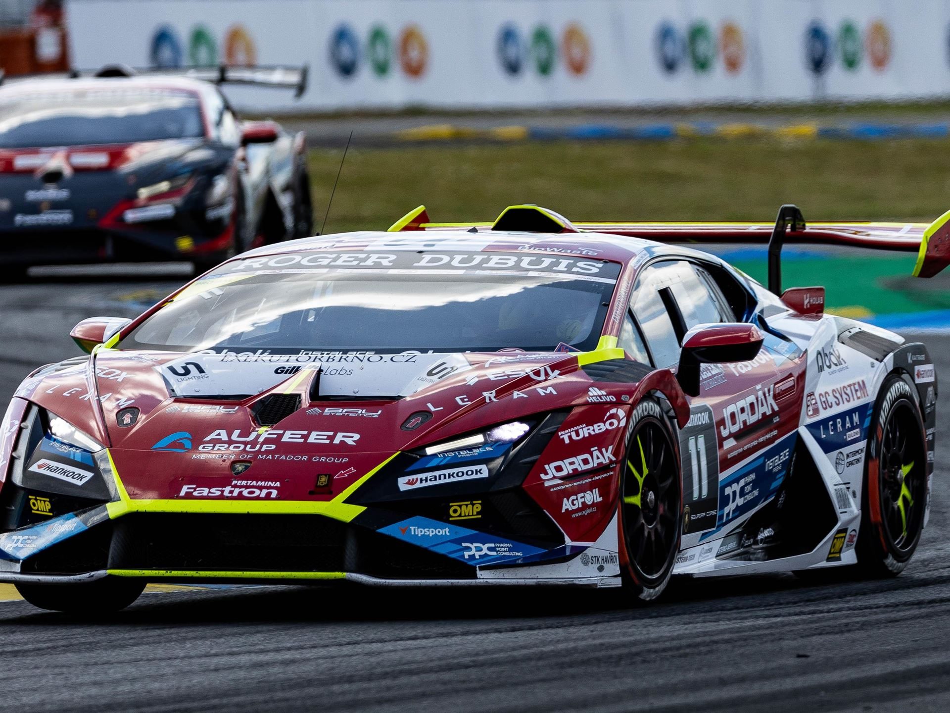 Super Trofeo Europe Hits The Nürburgring With A 1.5-Point Pro Title Fight 5 A red, white, and blue lamborghini huracán super trofeo evo2 at speed on track with another car visible in the background