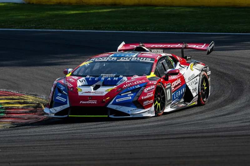 A Lamborghini Huracán Super Trofeo EVO2 in red, white, and blue livery carving through a corner at Spa-Francorchamps