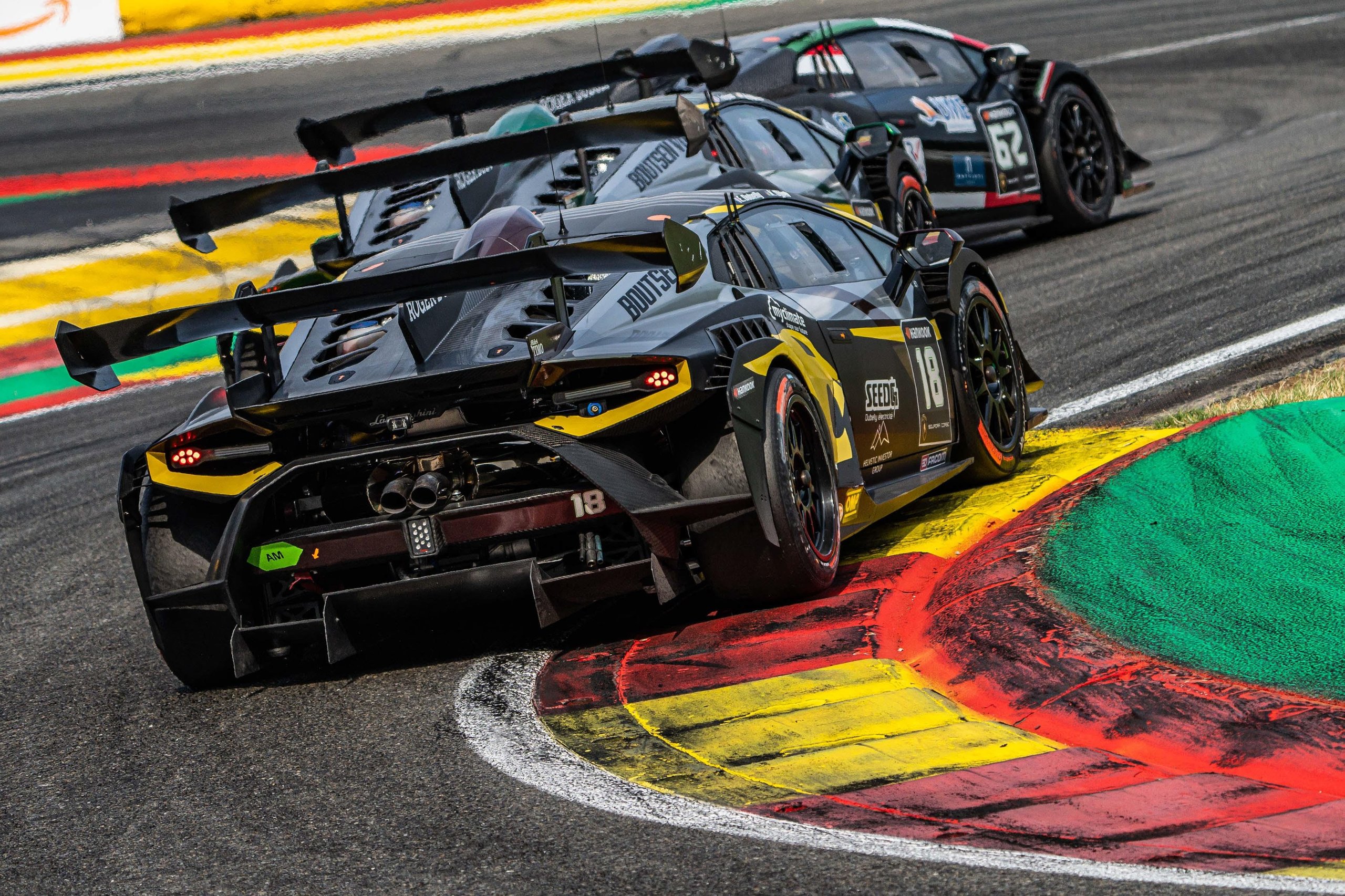 52 Huracán Evo2S At Vallelunga: Why The Super Trofeo'S Record Grid Matters Beyond The Championship Fight 9 A black and yellow lamborghini huracán super trofeo evo2 navigates a sharp corner with colorful curbing visible