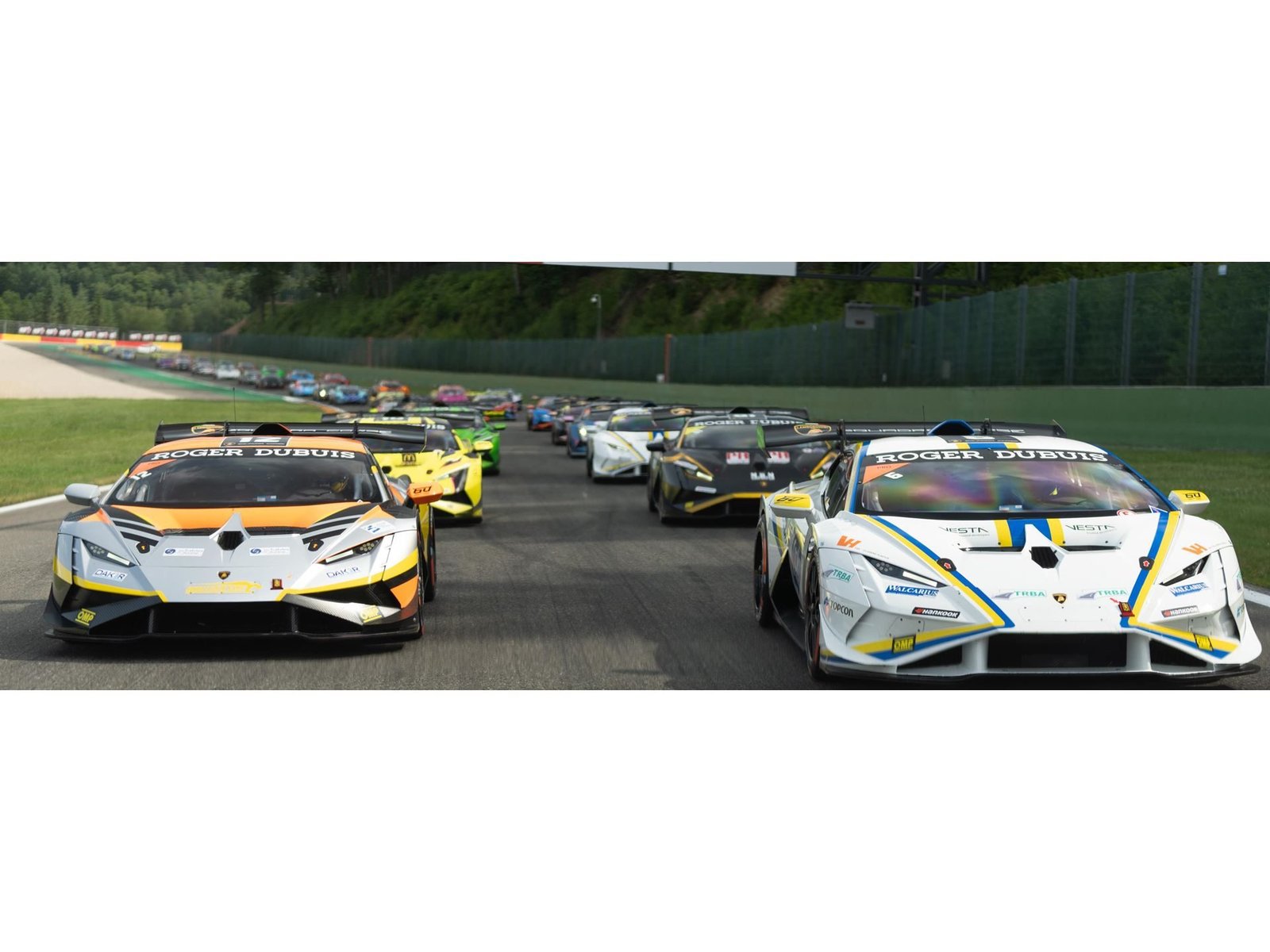 A packed grid of Lamborghini Huracán Super Trofeo EVO2 race cars lined up on a racetrack, showcasing the record entry for the 2023 Vallelunga round