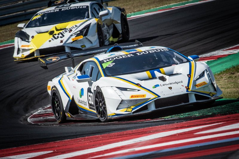 Two Lamborghini Huracán Super Trofeo EVO2 race cars battling through a corner at Misano Adriatico