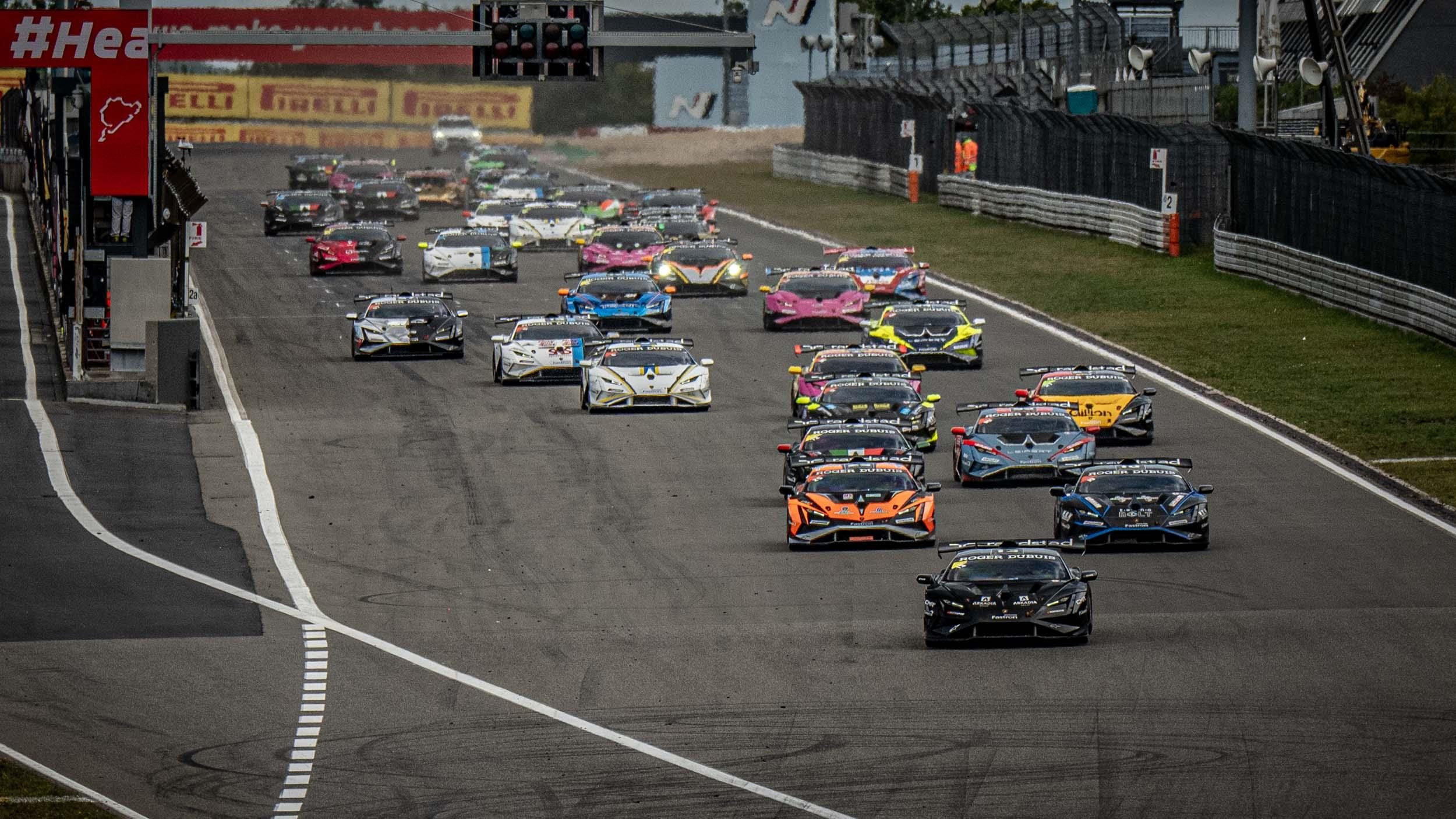 Full grid of lamborghini huracán super trofeo evo2 race cars lined up on the nürburgring circuit
