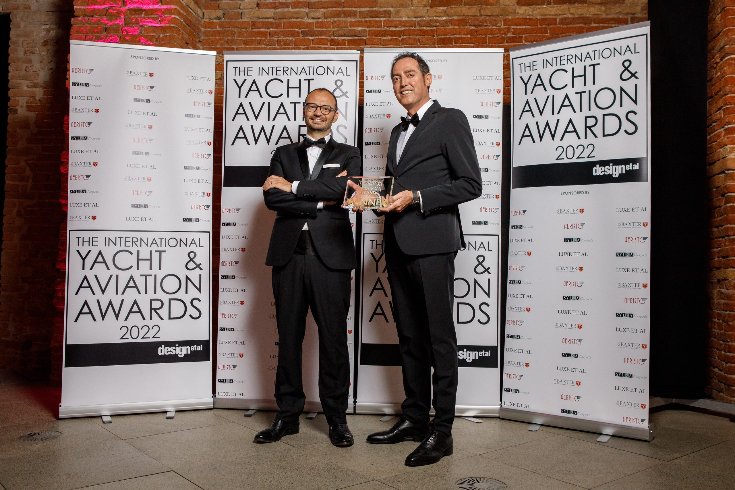 Tecnomar For Lamborghini 63 Wins International Yacht Design Award, Proving The Raging Bull'S Design Dna Travels Well Beyond Asphalt 5 Two men in black tuxedos holding winner award at the 2022 international yacht and aviation awards ceremony