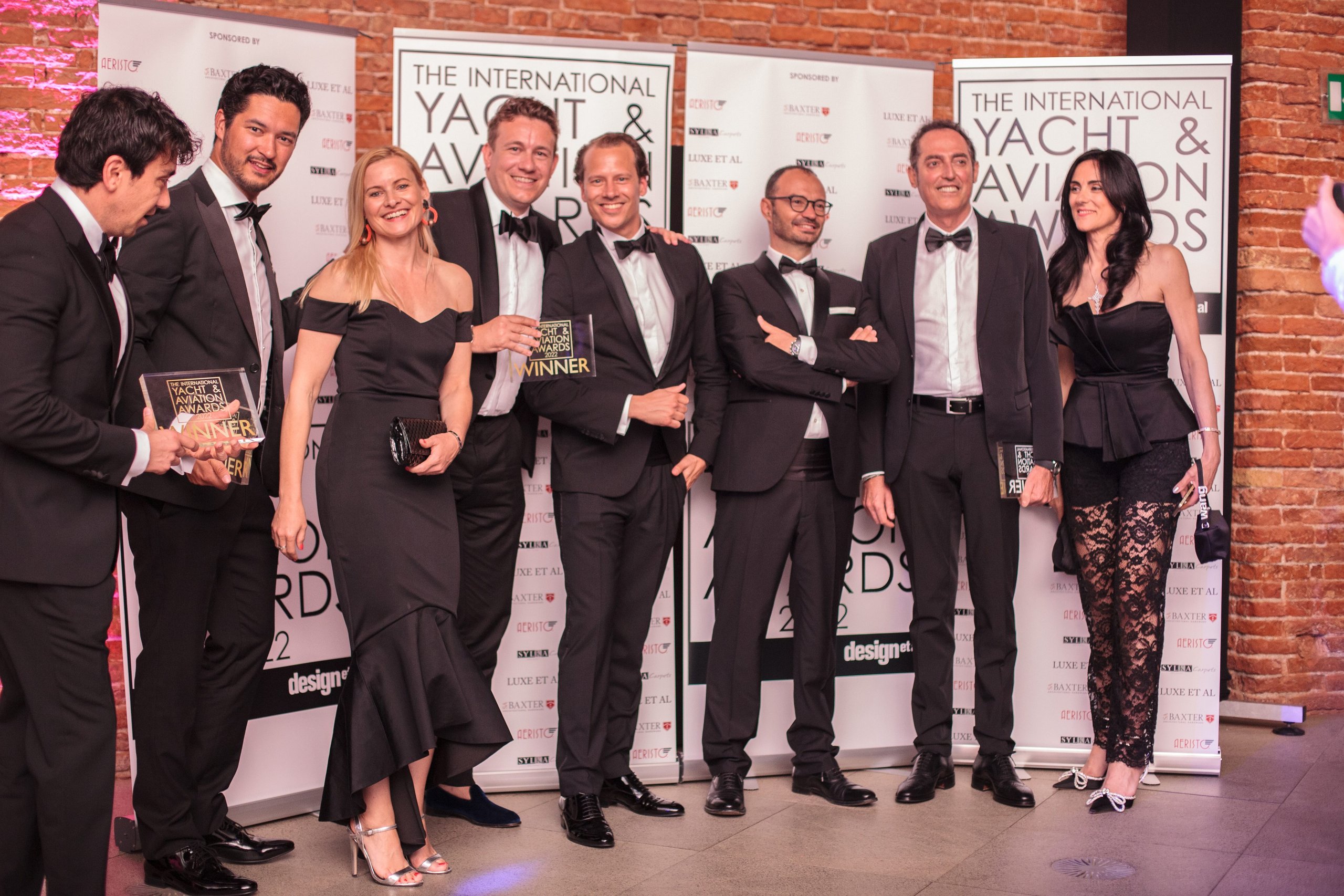 Tecnomar For Lamborghini 63 Wins International Yacht Design Award, Proving The Raging Bull'S Design Dna Travels Well Beyond Asphalt 7 Group of elegantly dressed men and women posing with winner awards at the 2022 international yacht and aviation awards ceremony