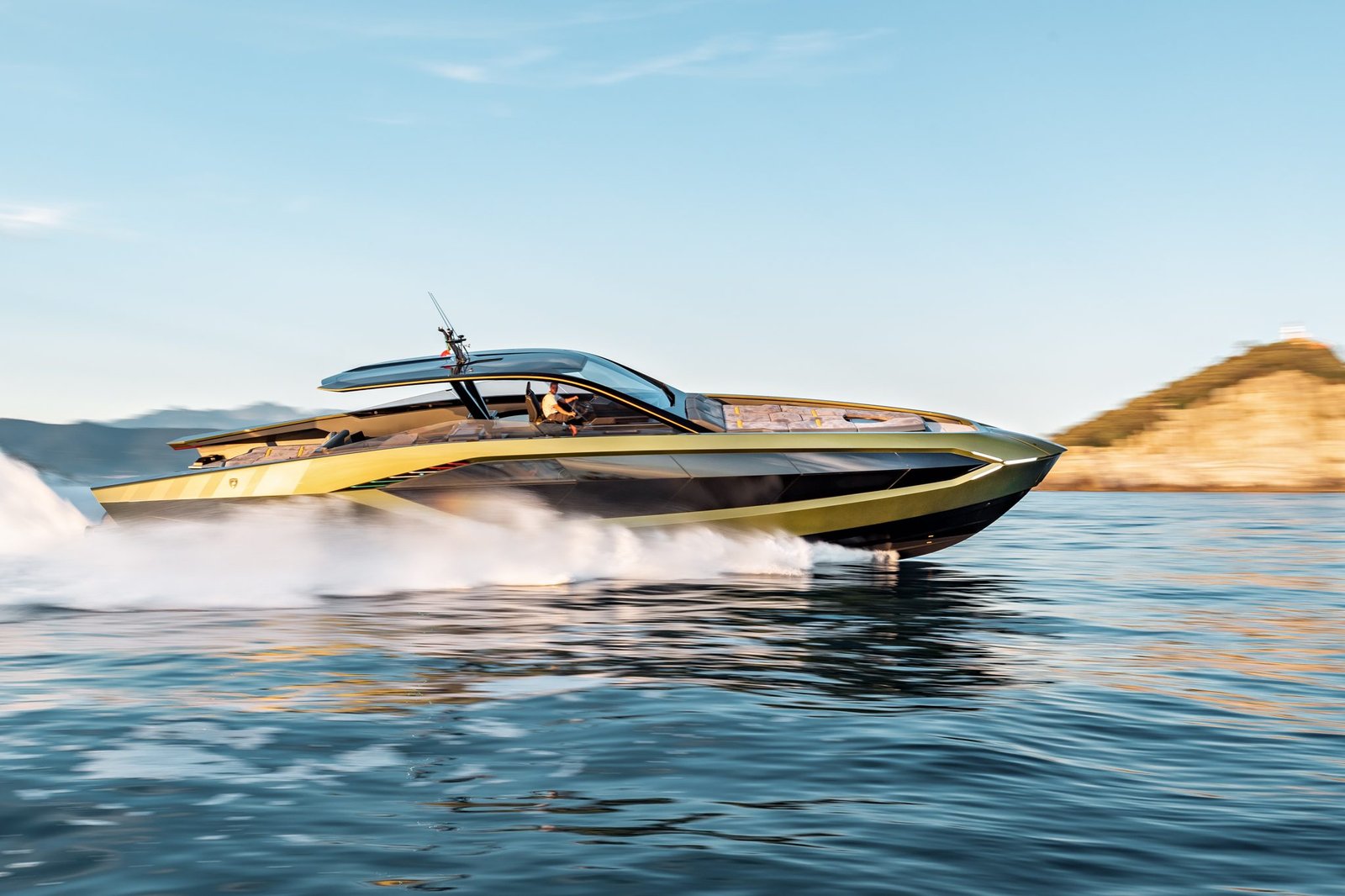 Tecnomar for Lamborghini 63 yacht in gold and black livery speeding across the ocean with a large white wake