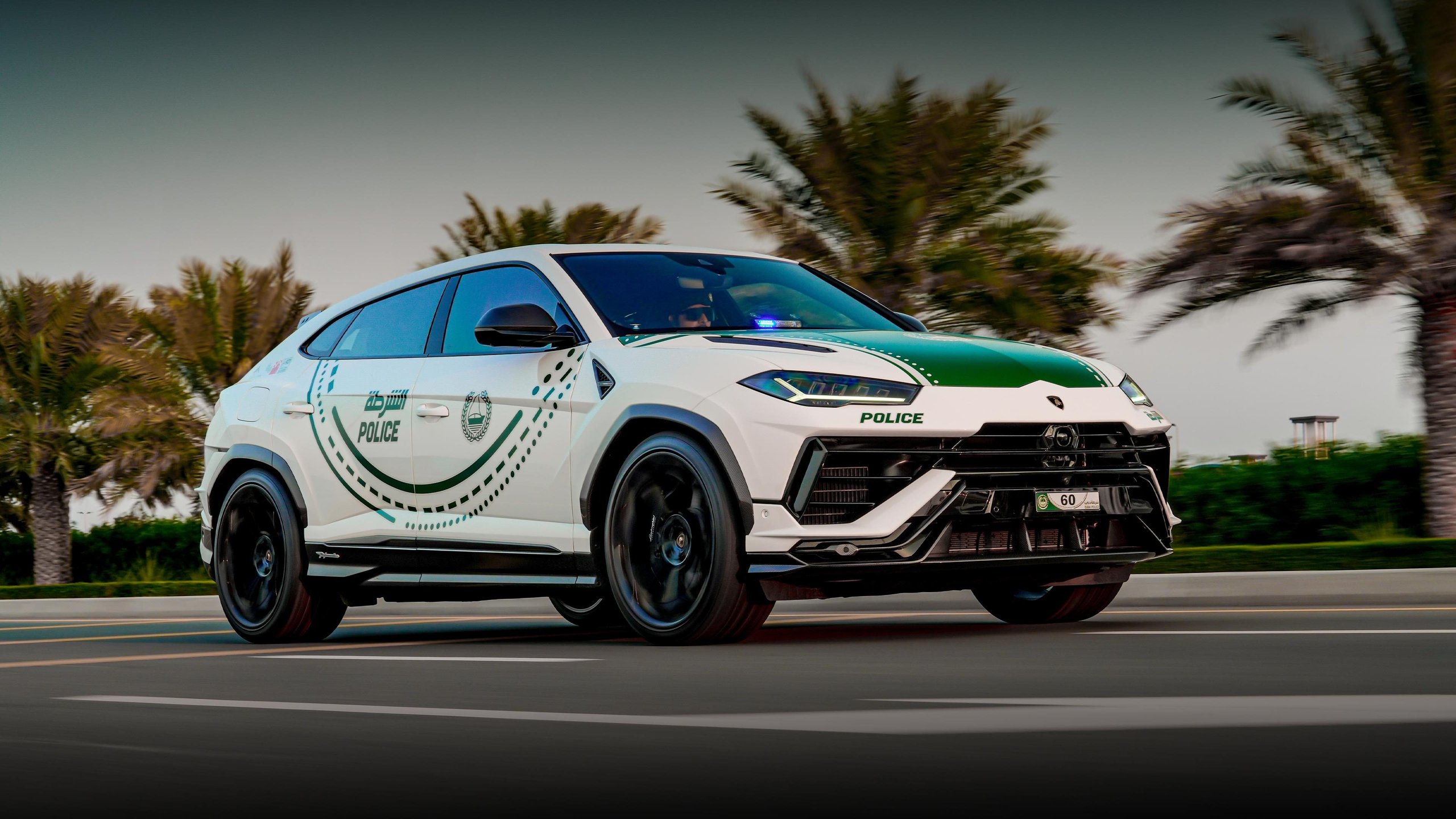 Dubai Police'S Urus Performante Is Lamborghini'S Most Calculated Brand Play In The Middle East 9 White lamborghini urus performante with dubai police livery driving on a multi-lane road with palm trees, showing dynamic presence and police modifications