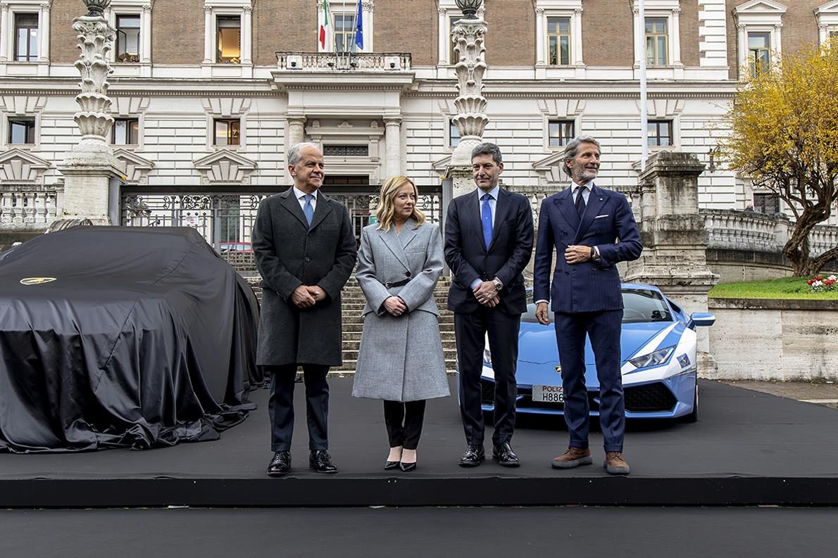 Italy'S Fastest Ambulance: The Urus Performante Now Runs Organs For The Highway Police 5 Officials standing in front of a covered vehicle and the lamborghini huracán in police livery at the rome ceremony
