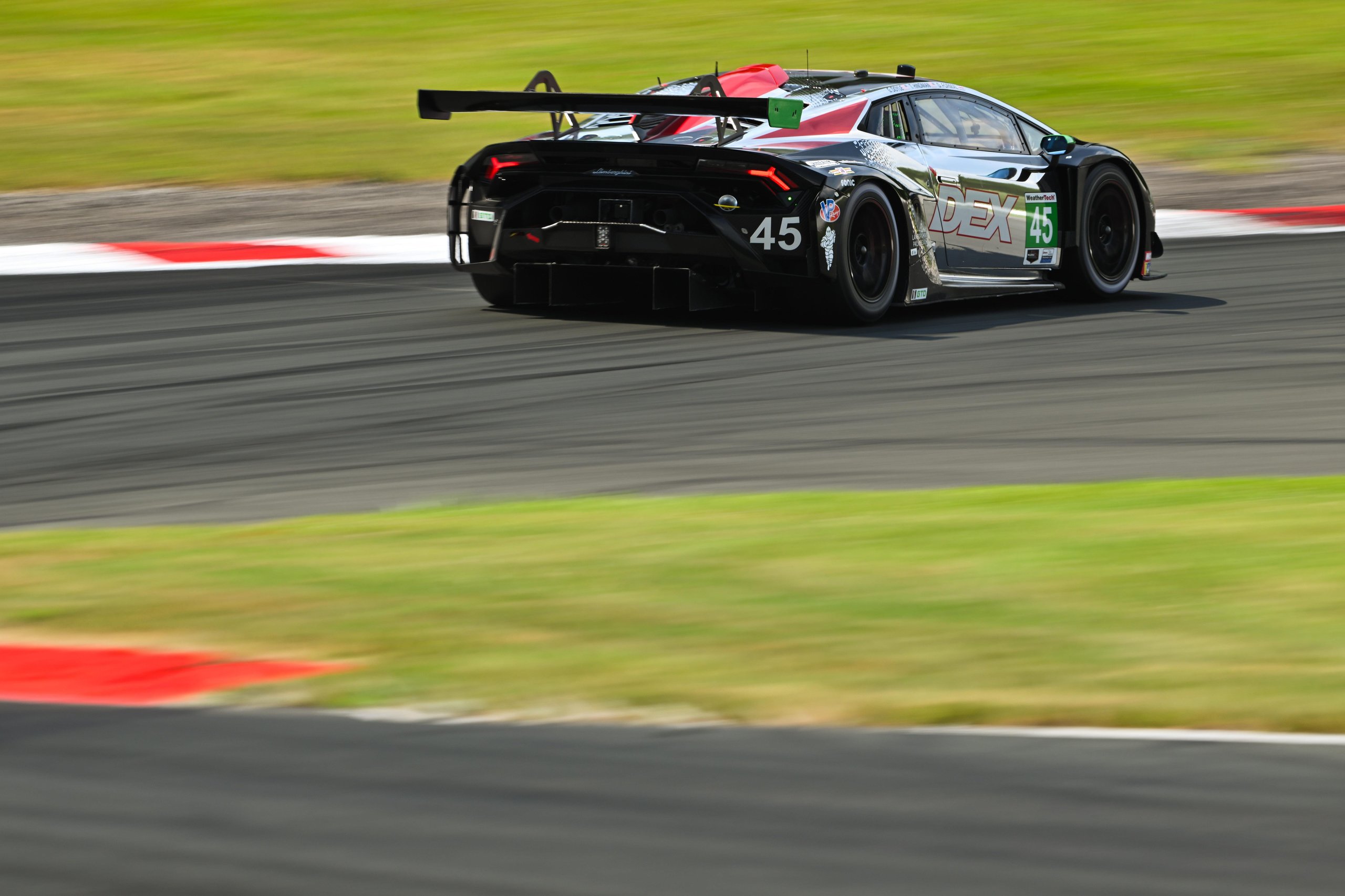 How Wayne Taylor Racing Turned A Cracked Rim And A Lap-One Spin Into Lamborghini'S First Imsa Win Of 2025 5 Rear view of the #45 lamborghini huracán gt3 evo2 at speed showing the prominent rear wing, diffuser, and racing exhaust