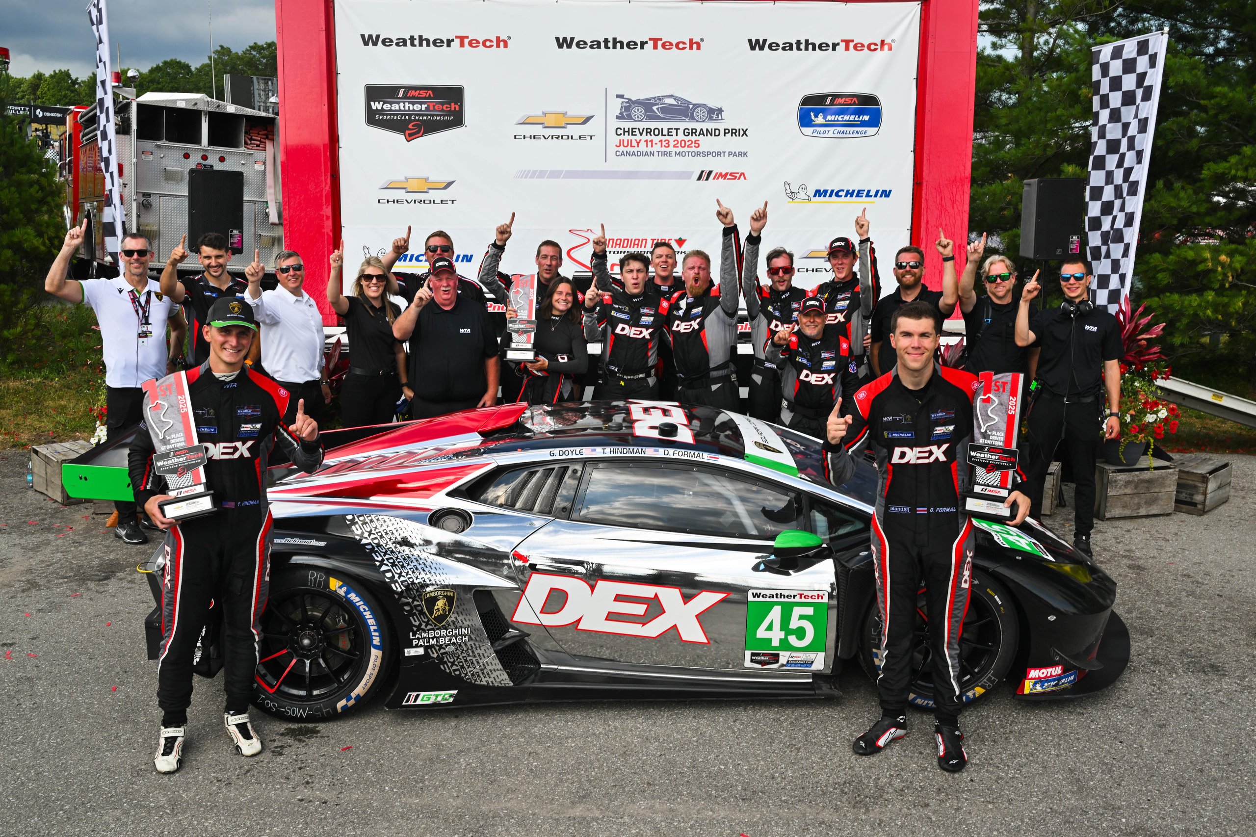 How Wayne Taylor Racing Turned A Cracked Rim And A Lap-One Spin Into Lamborghini'S First Imsa Win Of 2025 9 The full wayne taylor racing team celebrating their mosport victory alongside the #45 lamborghini huracán gt3 evo2