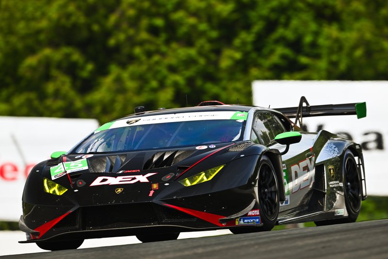 The #45 Wayne Taylor Racing Lamborghini Huracán GT3 EVO2 in black livery with green and red accents racing at speed on the Mosport circuit