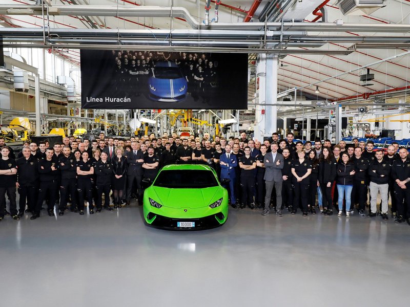 The 10,000th Lamborghini Huracán Performante in Verde Mantis on the Sant'Agata Bolognese assembly line, surrounded by factory workers and executives