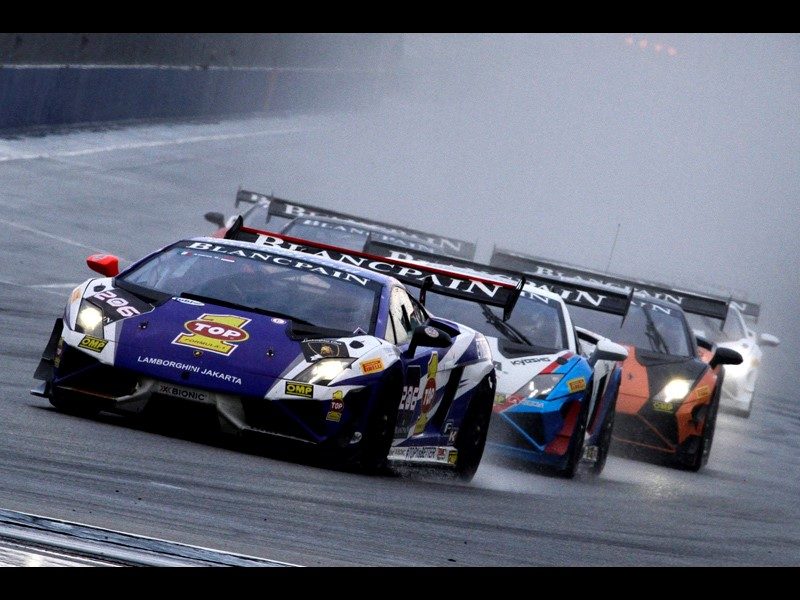 Lamborghini Gallardo Super Trofeo race cars navigate a wet Sepang International Circuit during the 2014 Blancpain Super Trofeo Asia World Final