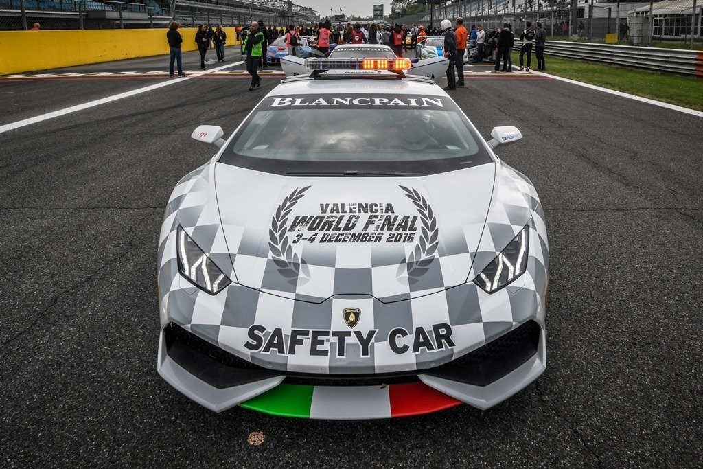 White Lamborghini Huracán safety car with checkered livery and roof-mounted light bar at the Valencia Ricardo Tormo circuit during the 2016 World Final