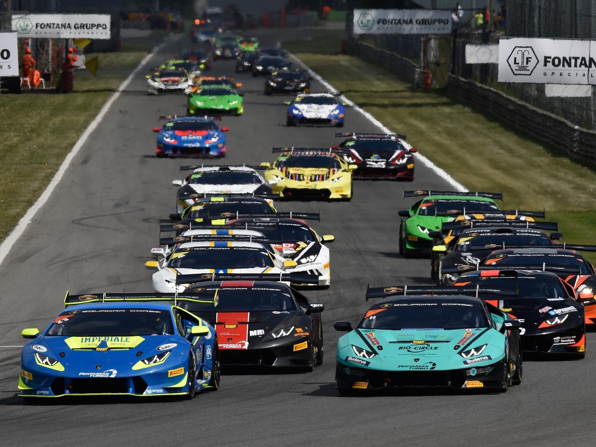 Multiple Lamborghini Huracán Super Trofeo race cars battling for position on track during the 2017 Super Trofeo Europe season opener at Monza