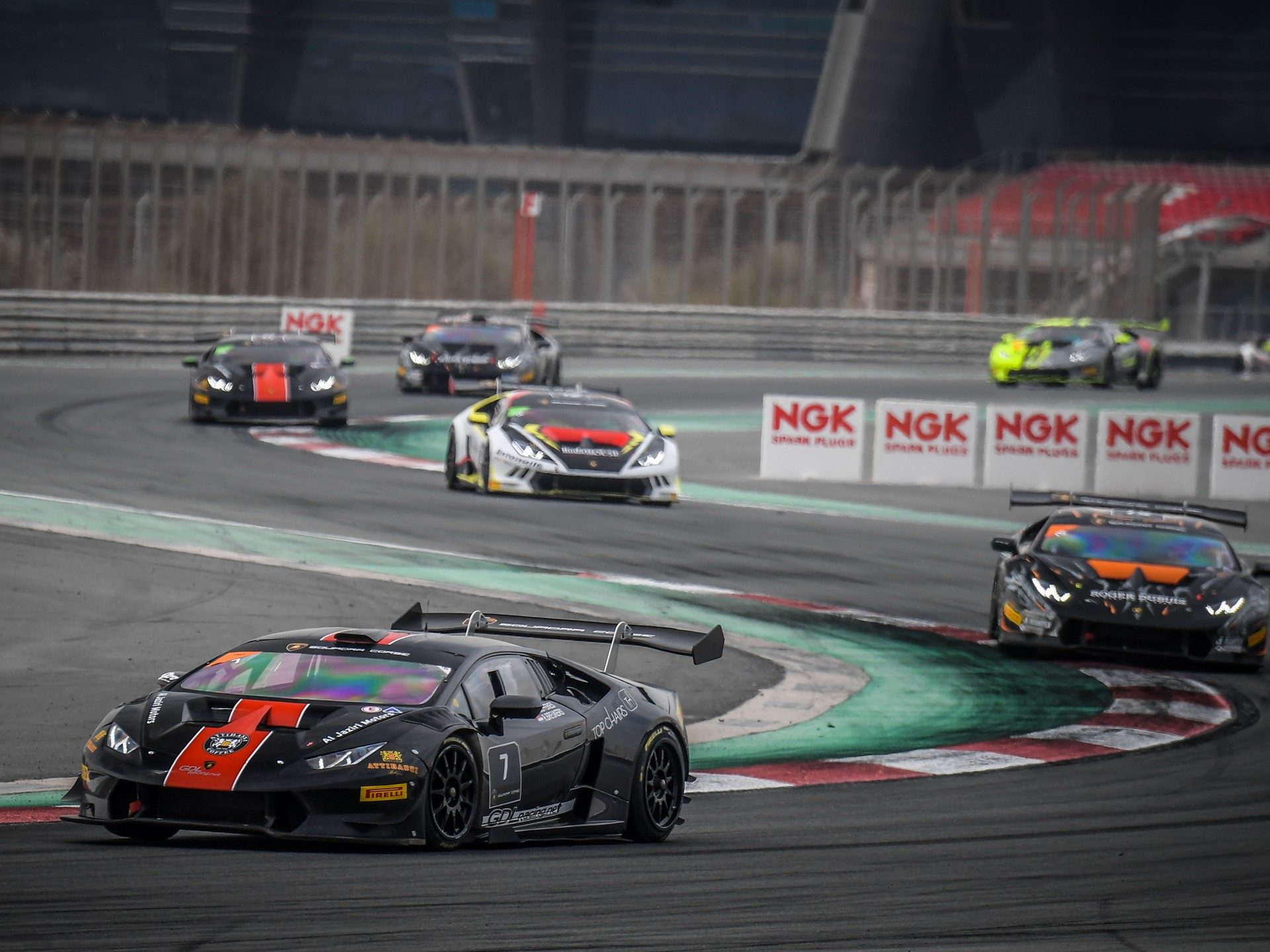 Lamborghini Huracán Super Trofeo race cars battling through a corner during the 2017 Super Trofeo Middle East series