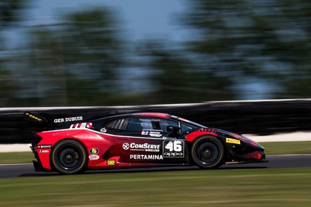Red and black Lamborghini Huracán Super Trofeo Evo race car at speed on a racetrack during the 2018 Road America round