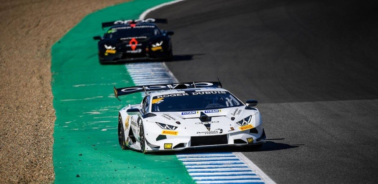 Two lamborghini huracán super trofeo evo race cars battling through a corner at a racing circuit