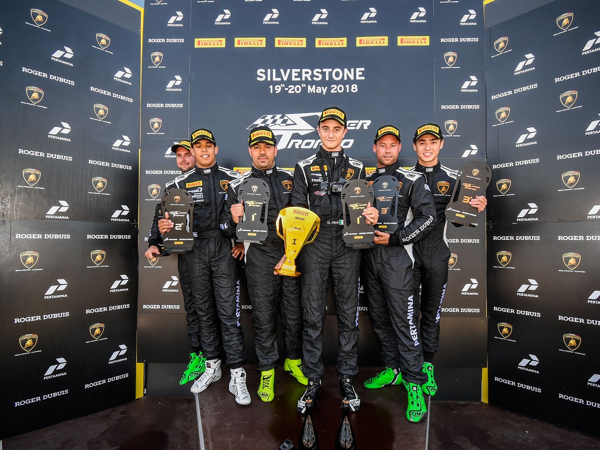 Five Lamborghini Super Trofeo drivers on the Silverstone podium holding trophies, May 2018