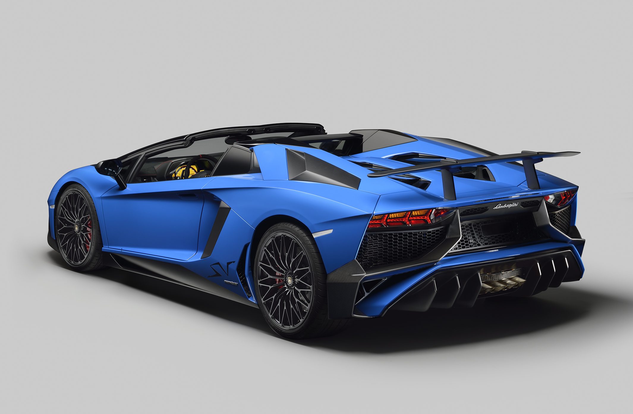 Blue Lamborghini Aventador LP 750-4 Superveloce Roadster rear three-quarter view showing open-top configuration and exposed engine bay area