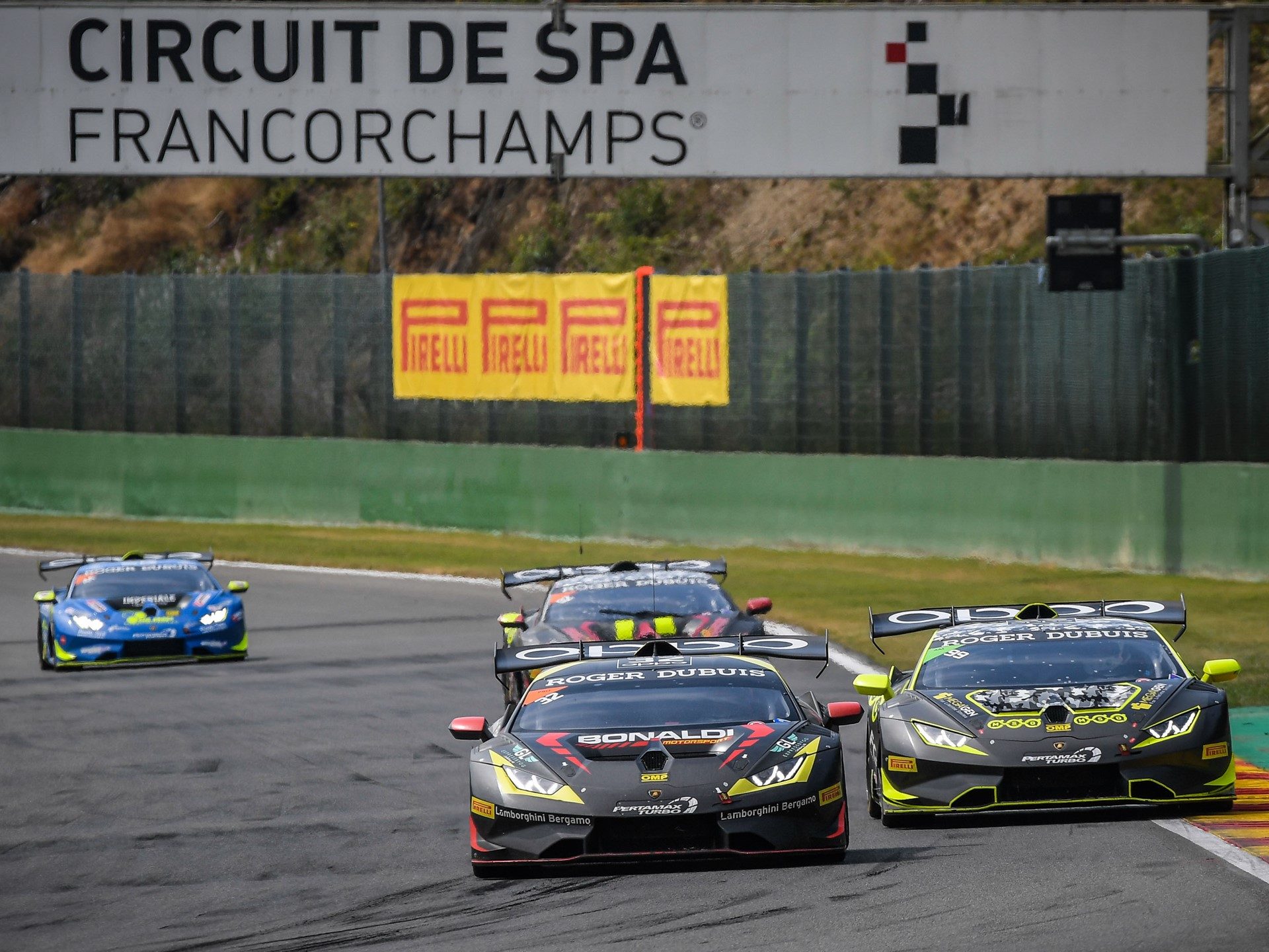 Lamborghini Huracán Super Trofeo EVO cars racing in close formation at Spa-Francorchamps