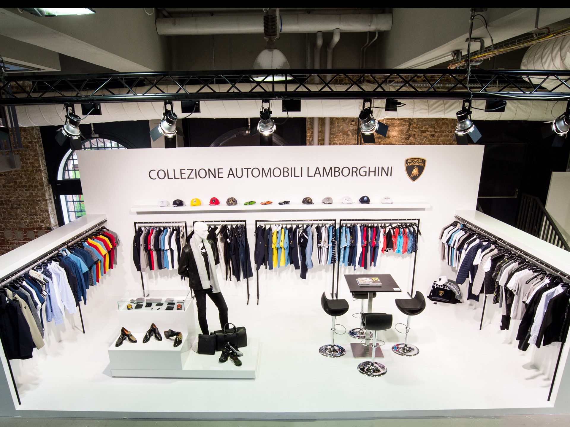 Collezione Automobili Lamborghini display at Premium Berlin 2017 with apparel racks, mannequins, and branded accessories