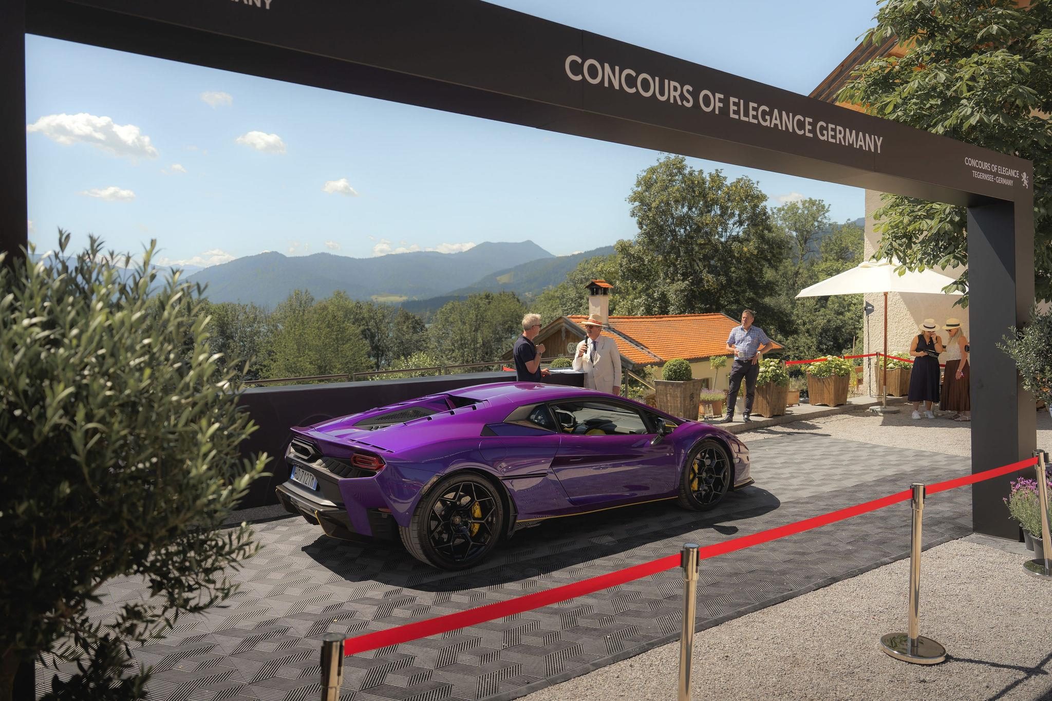 Fenomeno Roadster At Lake Tegernsee: Why Lamborghini Chose A Concours Lawn Over A Motor Show Stage 3 Purple lamborghini fenomeno roadster driving under the concours of elegance germany banner with mountains in the background