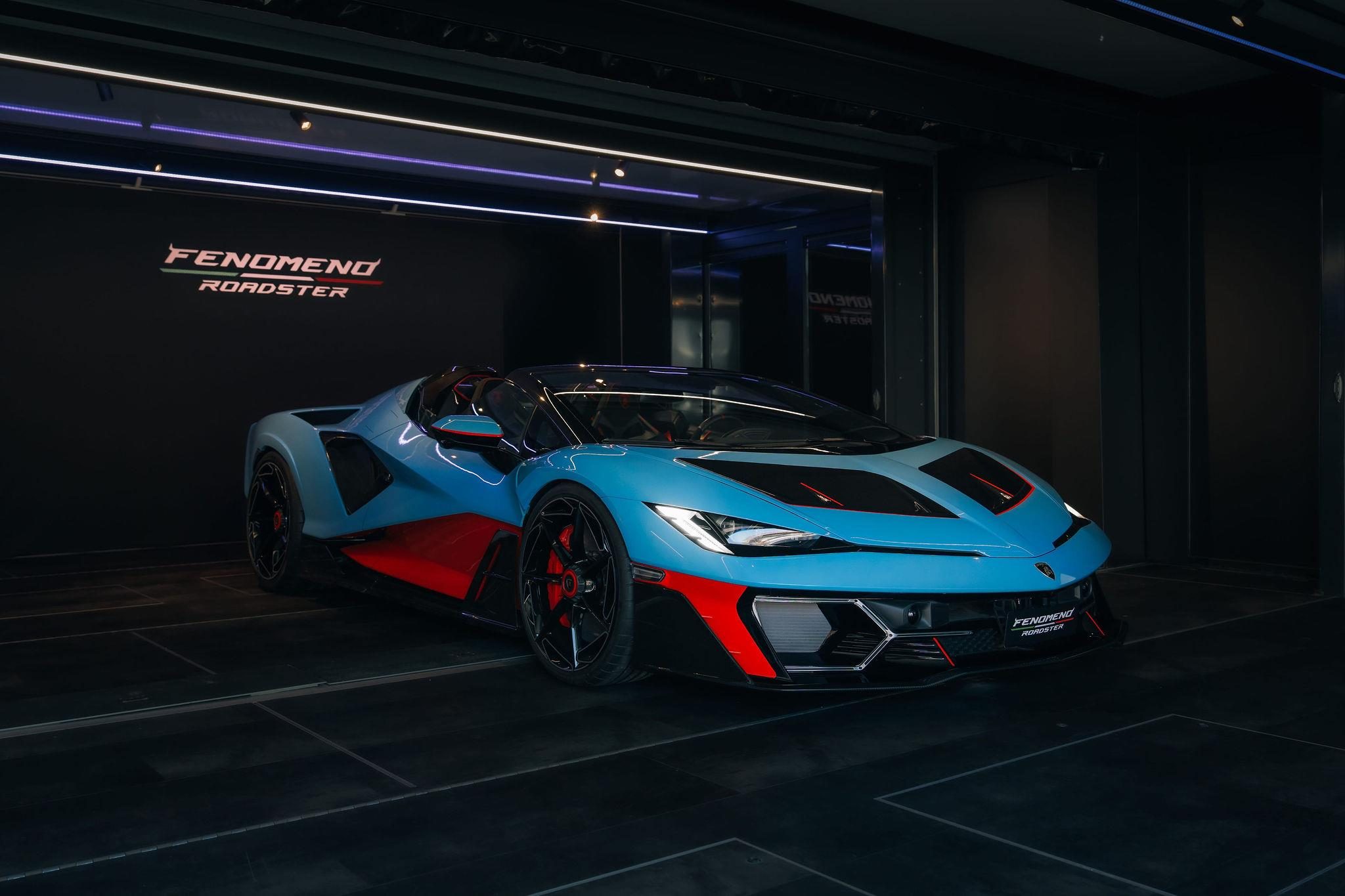 Fenomeno Roadster At Lake Tegernsee: Why Lamborghini Chose A Concours Lawn Over A Motor Show Stage 5 Blue and red lamborghini fenomeno roadster displayed indoors on a black platform with fenomeno roadster branding
