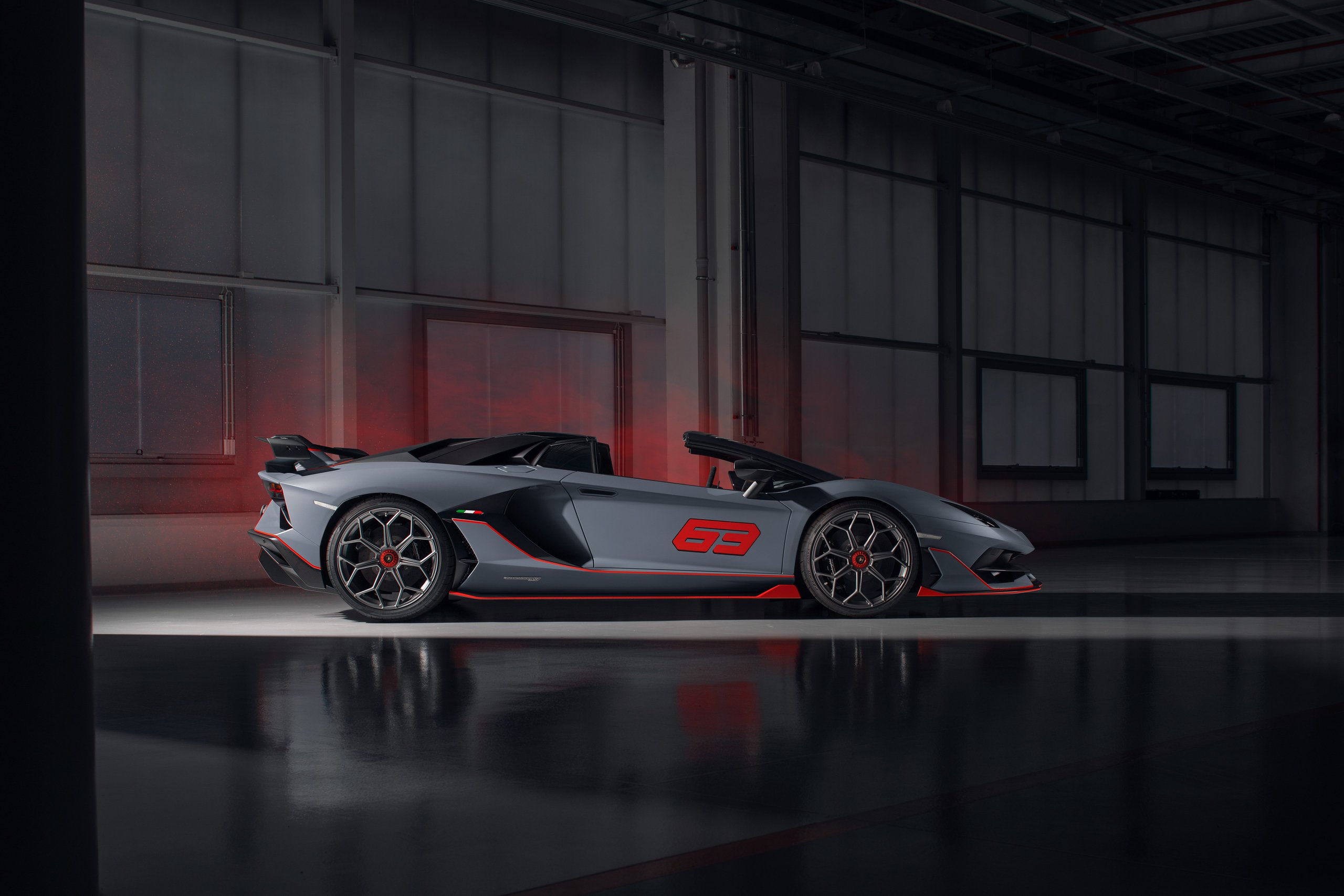 Side profile of the aventador svj 63 roadster with roof removed, showing open-top configuration and carbon fiber upper body