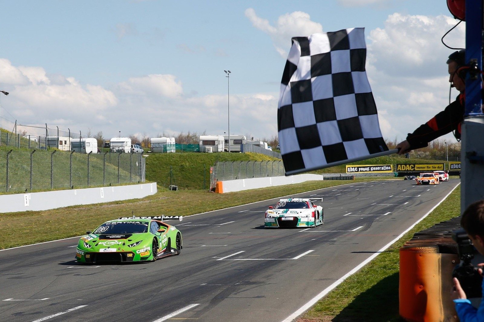 Green Lamborghini Huracán GT3 takes the checkered flag at the 2016 ADAC GT Masters at Oschersleben