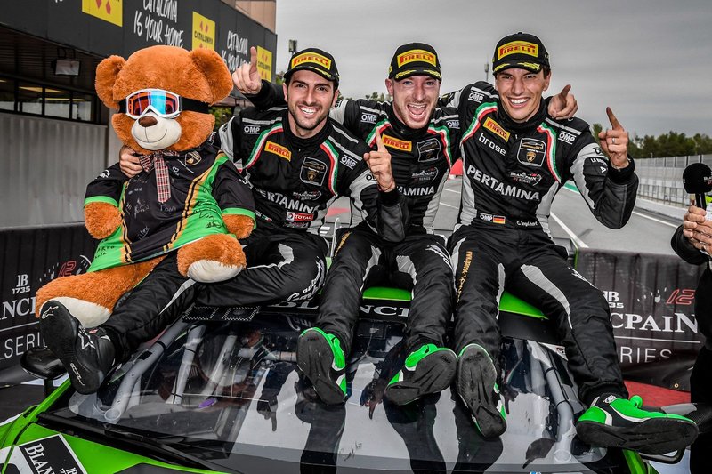 Lamborghini Squadra Corse factory drivers Mirko Bortolotti, Christian Engelhart, and Andrea Caldarelli celebrate on the hood of the championship-winning Grasser Racing Huracán GT3 number 63