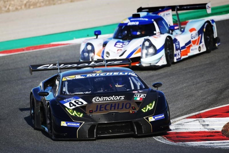 Black Lamborghini Huracán GT3 race car with yellow accents leading on track during the Michelin GT3 Le Mans Cup