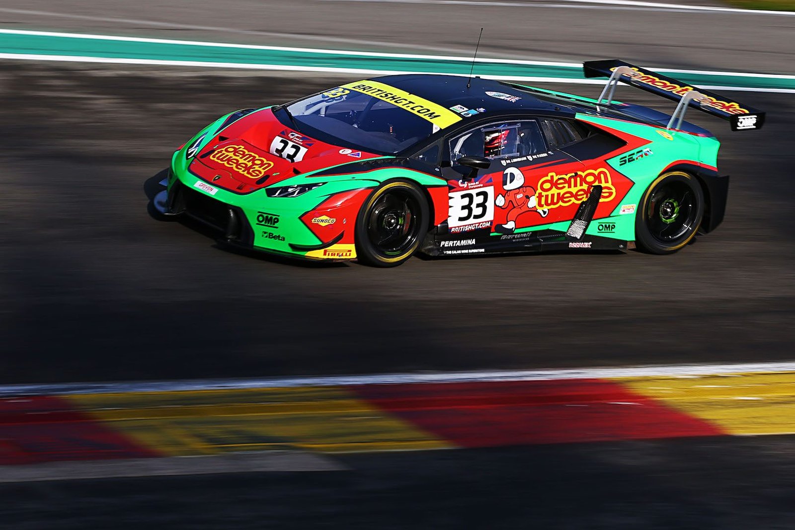 Barwell Motorsport Lamborghini Huracán GT3 in red, green, and black racing livery at speed on track during the 2017 British GT Championship at Spa-Francorchamps