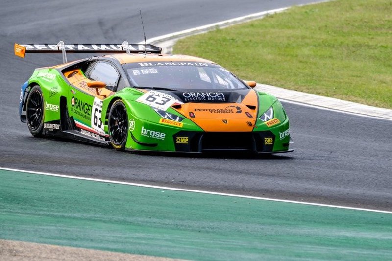 Green and orange Lamborghini Huracán GT3 racing on a wet circuit during the Blancpain GT Series Sprint Cup