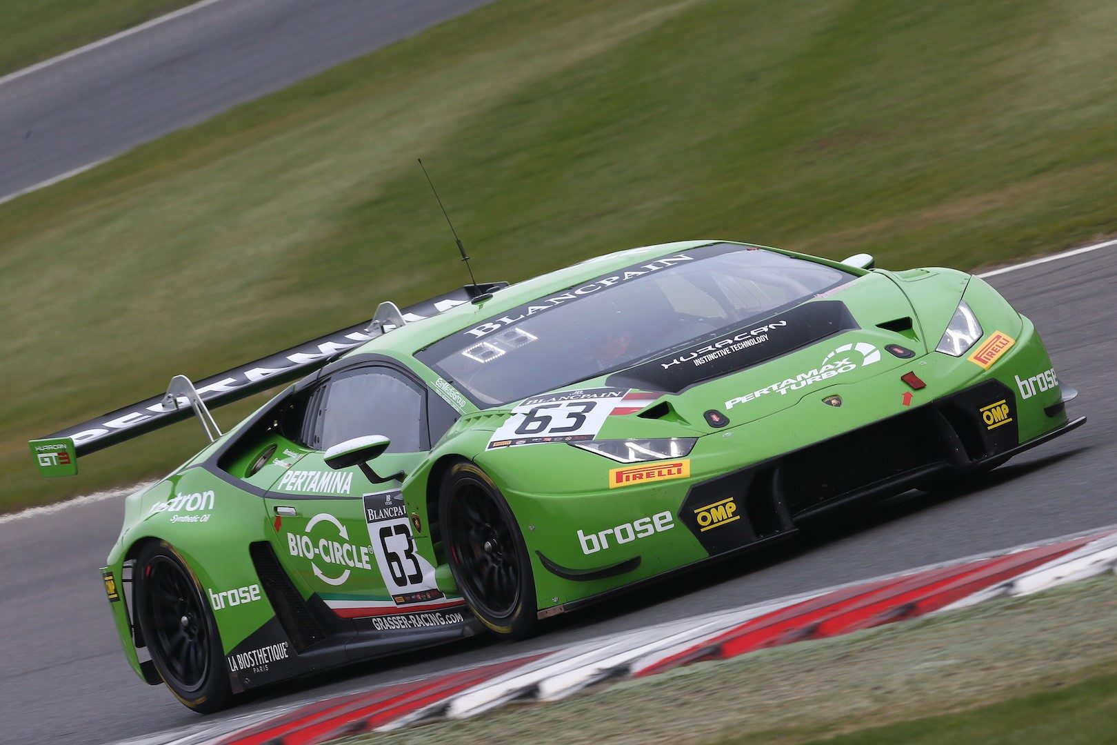 GRT Grasser Racing Team Lamborghini Huracán GT3 number 63 racing at Brands Hatch with visible rear wing, carbon diffuser, and racing slicks