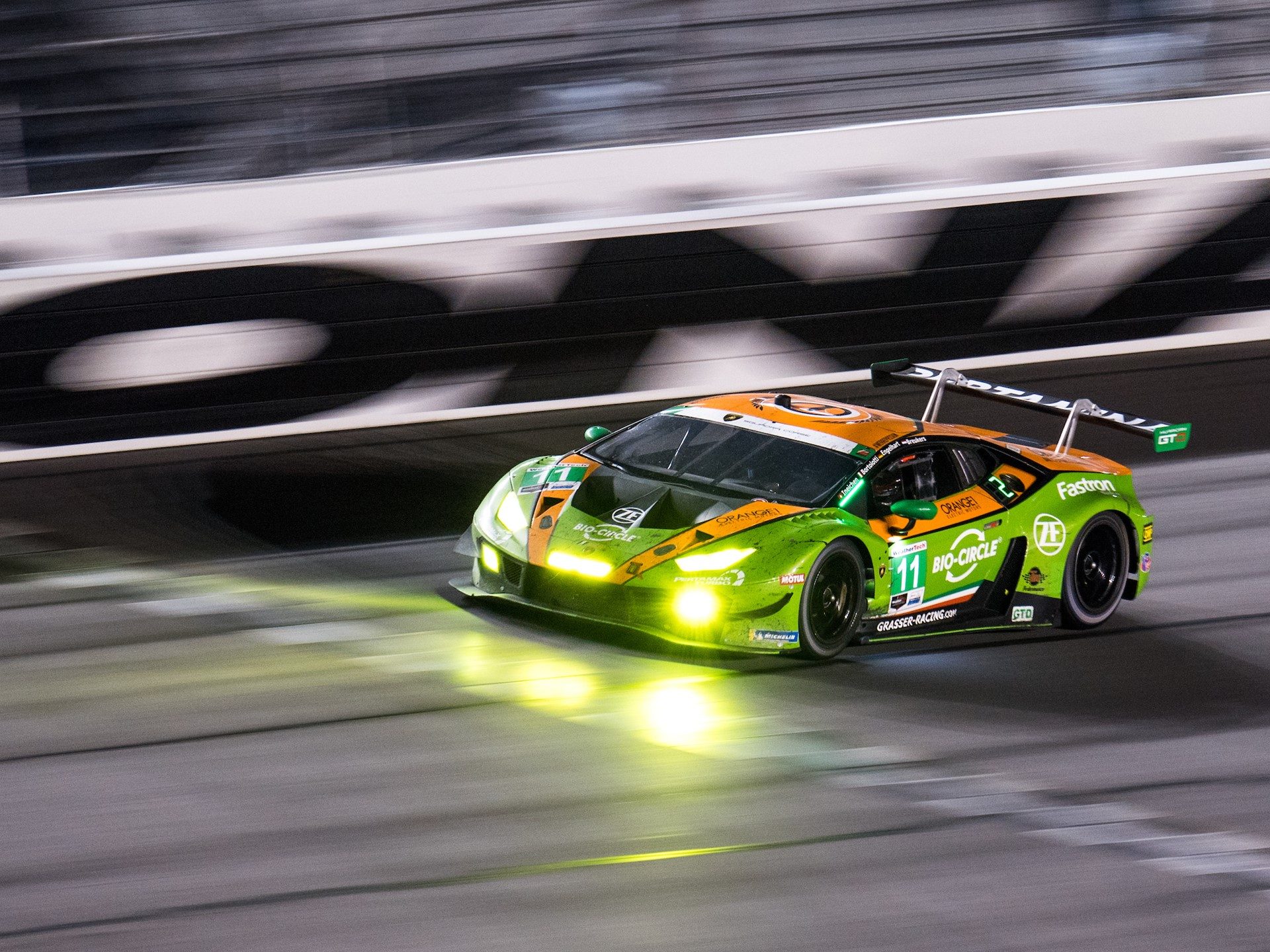 The #11 GRT Grasser Racing Lamborghini Huracán GT3 Evo at speed during the Rolex 24 at Daytona night session