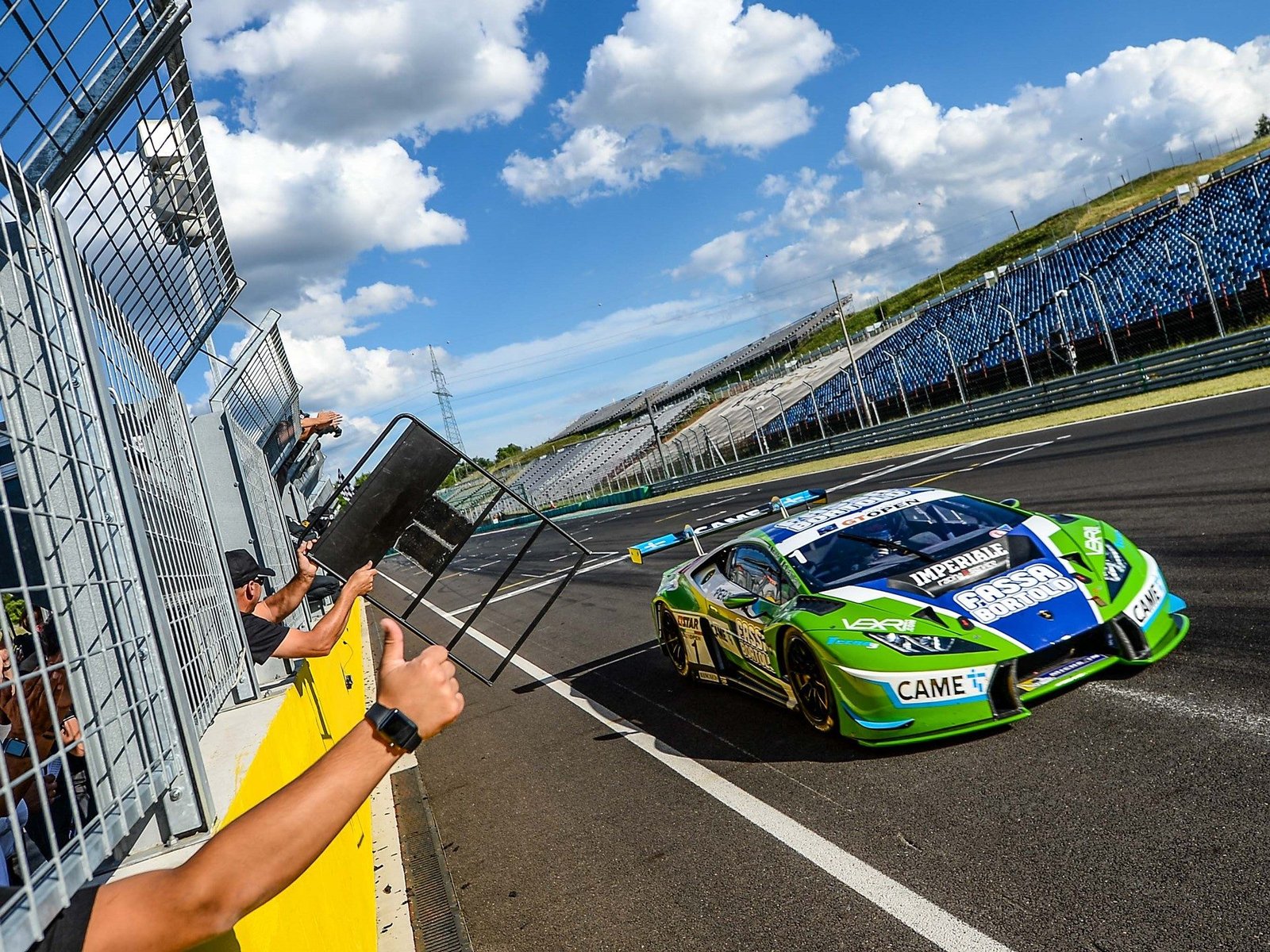 Imperiale Racing Lamborghini Huracán GT3 in green and blue livery racing past spectators at Hungaroring