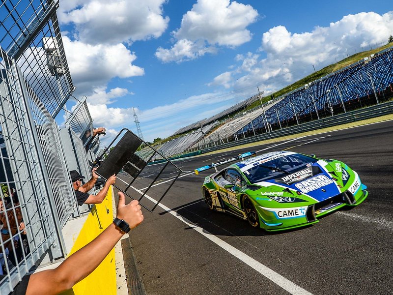 Imperiale Racing Lamborghini Huracán GT3 in green and blue livery racing past spectators at Hungaroring