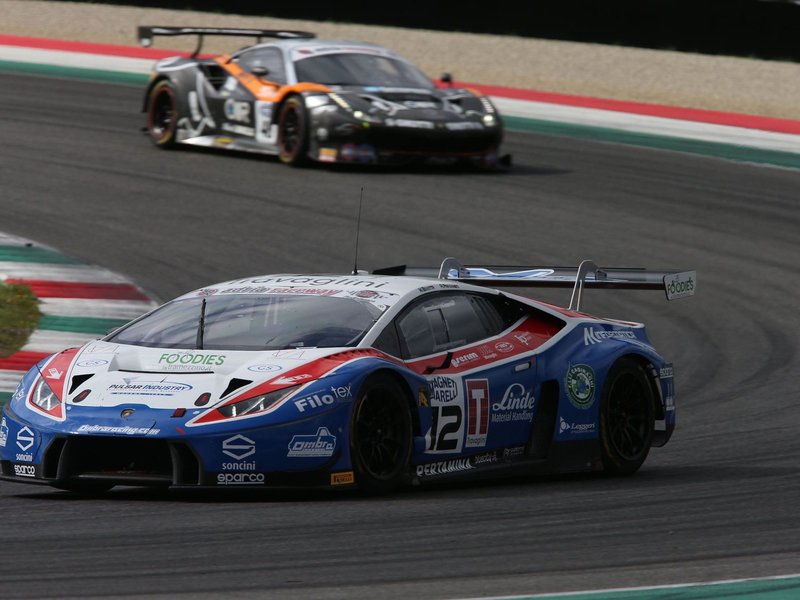 Lamborghini Huracán GT3 in blue, white, and red Ombra Racing livery navigating a turn during the Italian GT Championship