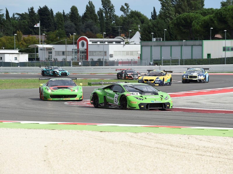 Green Lamborghini Huracan GT3 leading a pack of GT3 race cars on the Misano circuit during the 2015 Blancpain Sprint Series