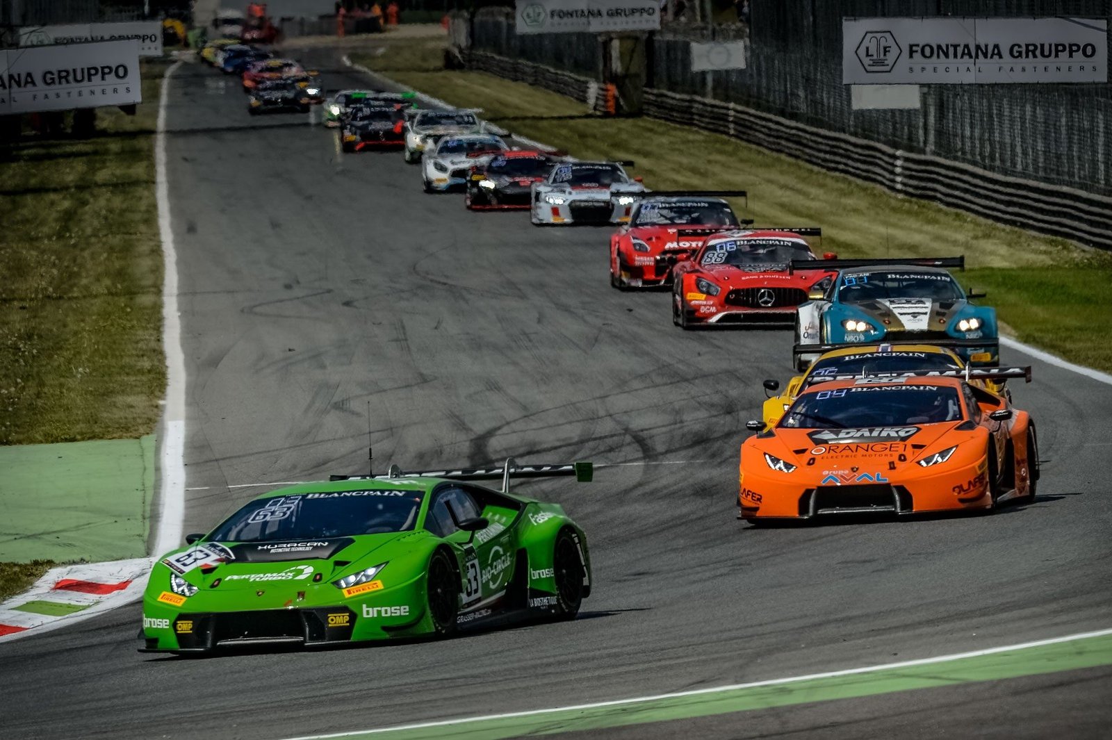 Green Lamborghini Huracán GT3 leading a pack of GT race cars at Monza during the 2017 Blancpain GT Series Endurance Cup