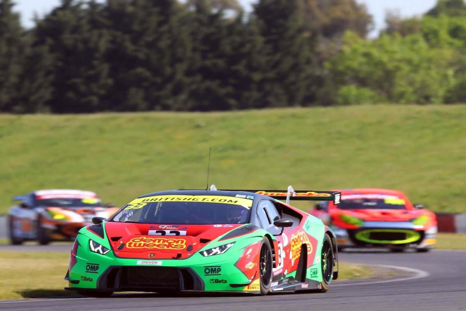 Barwell Motorsport Lamborghini Huracán GT3 in green and red livery racing at speed on a British GT circuit