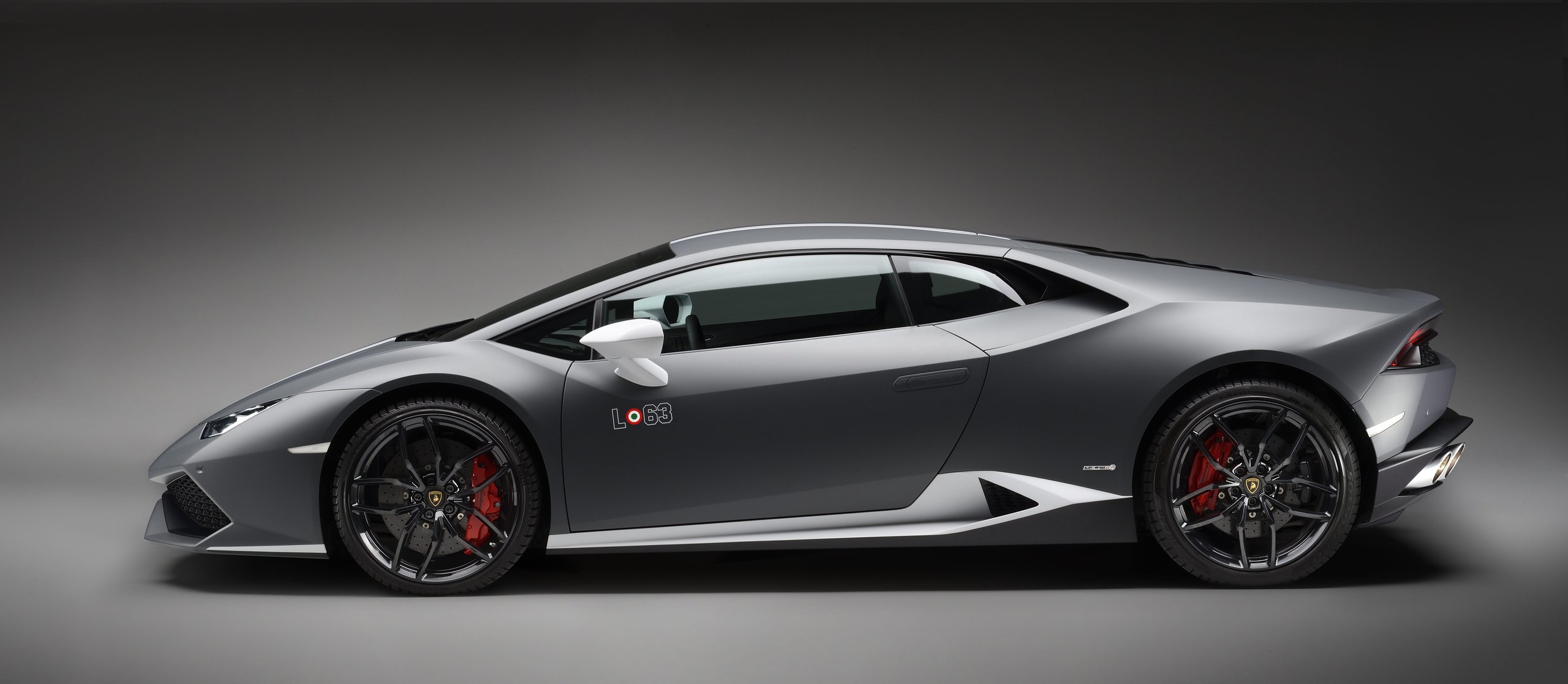 Grey Lamborghini Huracán Avio with white racing stripes shown in side profile, displaying the LO63 badge and aerodynamic silhouette