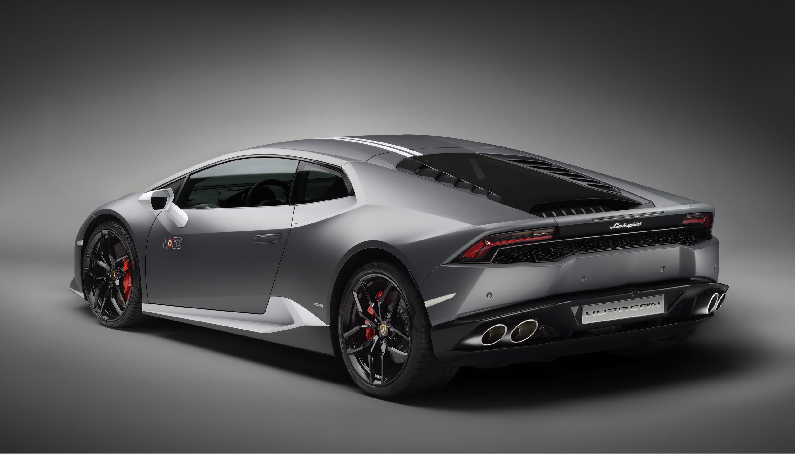 Rear three-quarter view of the grey Lamborghini Huracán Avio showing quad exhaust tips, red brake calipers, and rear diffuser